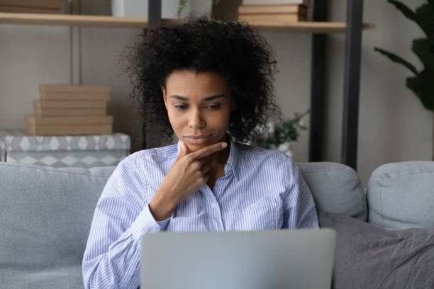 istock Thoughtful young black female freelancer read document on laptop screen 1341643972