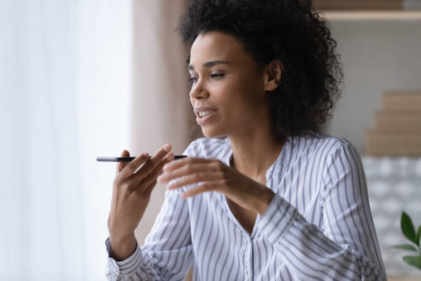 istock Millennial black female make phone call using voice dialing 1341644020
