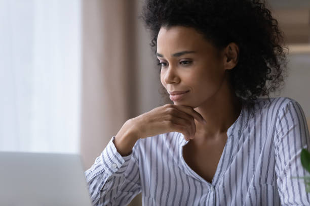 istock Focused millennial mixed race woman watch video training on pc 1341644023