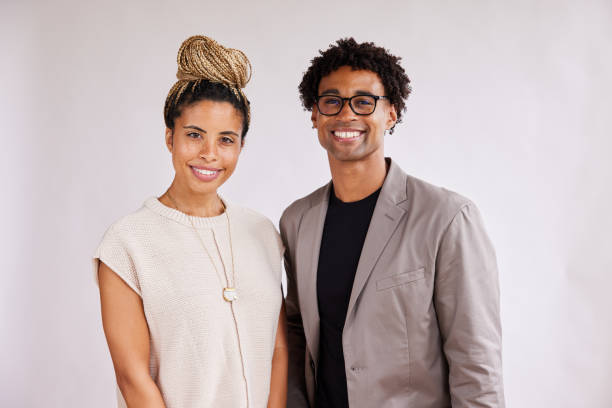 istock Confident young businesspeople standing against a white background and smiling 1341644095
