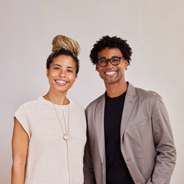 Smiling young businesspeople standing side by side together