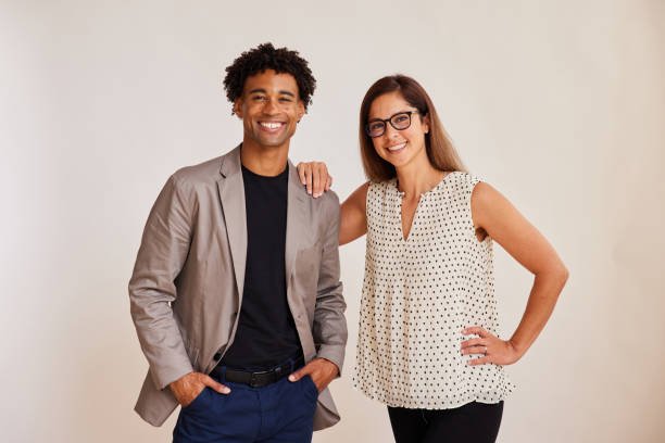 Diverse young businesspeople standing on a white background and smiling stock photo