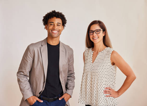 istock Two diverse young businesspeople standing together and smiling 1341645551