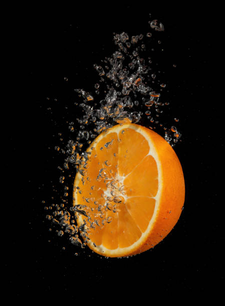 istock Orange slice splashing in water 1341646892