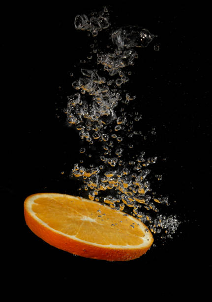istock Orange slice splashing in water 1341646899