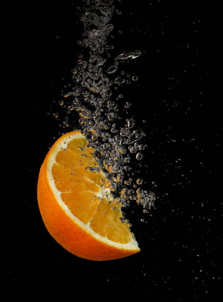 istock Orange slice splashing in water 1341646907