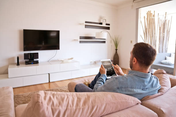 istock Man controlling smart devices with a digital tablet at home 1341647398