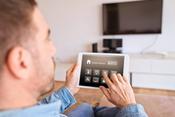 istock Man controlling smart devices with a digital tablet at home 1341647465