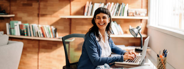 istock Businesswoman smiling while working from home 1341650653