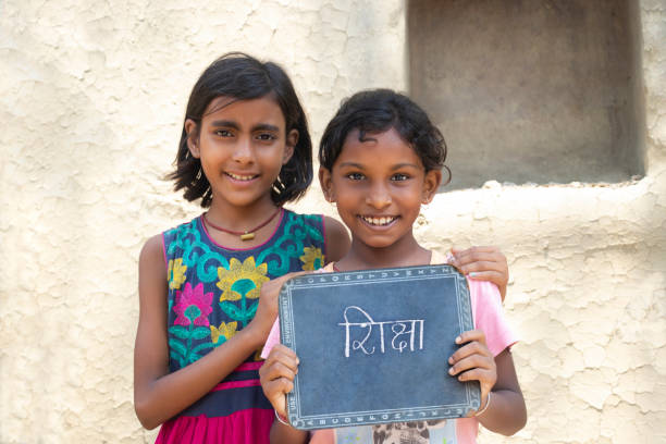 istock Two Indian rural  girls holding slate 1341652007
