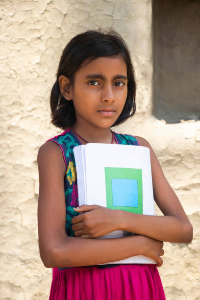 istock Indian rural girl holding books 1341652019