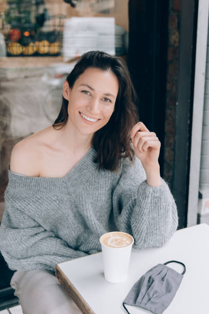 istock Young lady is drinking coffee at the cafe 1341653727