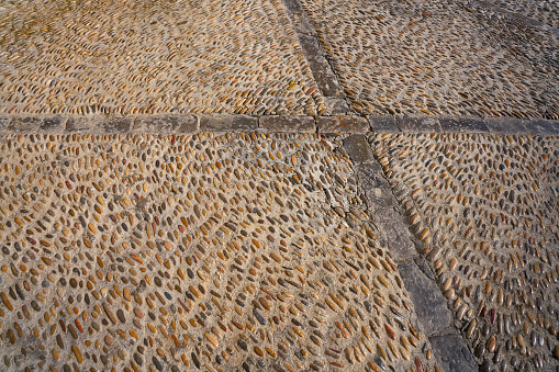 Full frame photo of a cobblestone road in daytime