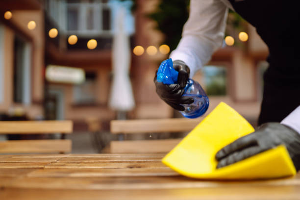 istock Waiter cleaning the table with Disinfectant Spray 1341653974