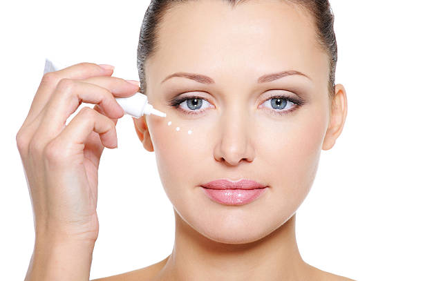 istock Woman with cosmetic cream for eyes 134165518
