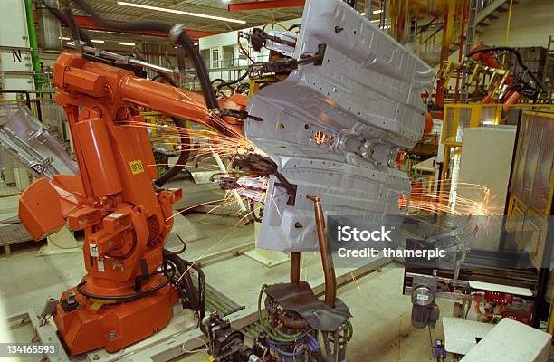 Sparks Are Flying From Industrial Welding Robot At Car Factory Stock Photo - Download Image Now