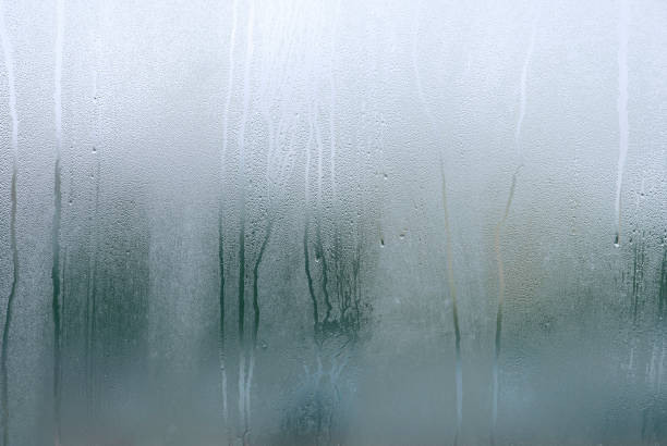 istock Window with condensate or steam after heavy rain, large texture or background 1341656807