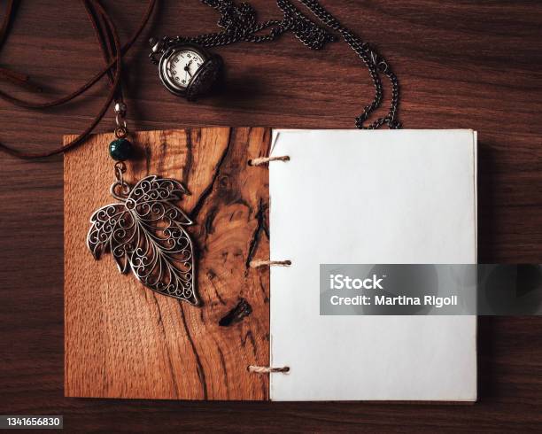 Blank Diary Page With Leaf Pendant And Pocket Watch On Wooden Background Flat Lay Stock Photo - Download Image Now