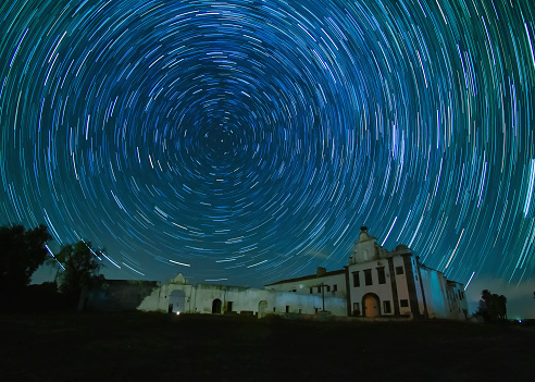 Photo of star traisl over an abandone monastery in the Alentejo district in the South of Portugal.