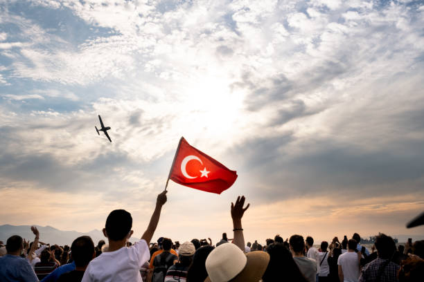 A plane flying on sky on the liberty day of Izmir for a demonstration. Izmir, Turkey - September 9, 2021: A plane flying on sky on the liberty day of Izmir for a demonstration. People waving a Turkish flag in the frame number 19 stock pictures, royalty-free photos & images