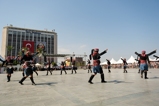 Izmir, Turkey - September 9, 2021: People performing Zeybek dance on the liberty day of Izmir at the Republic Square in Izmir.