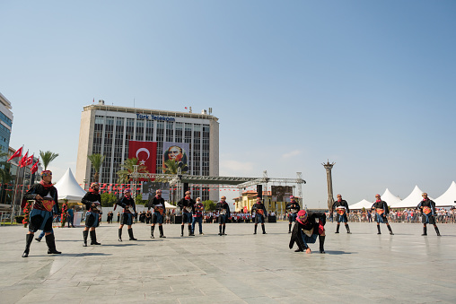 Izmir, Turkey - September 9, 2021: People performing Zeybek dance on the liberty day of Izmir at the Republic Square in Izmir.