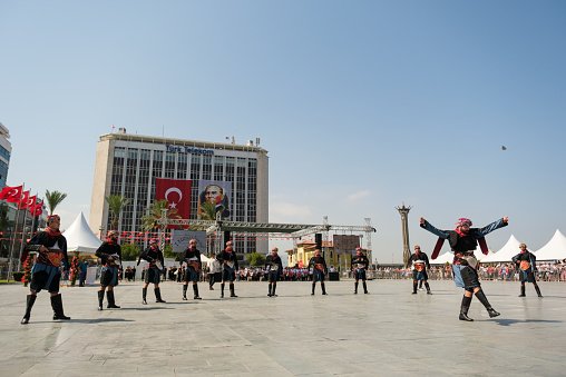 Izmir, Turkey - September 9, 2021: People performing Zeybek dance on the liberty day of Izmir at the Republic Square in Izmir.