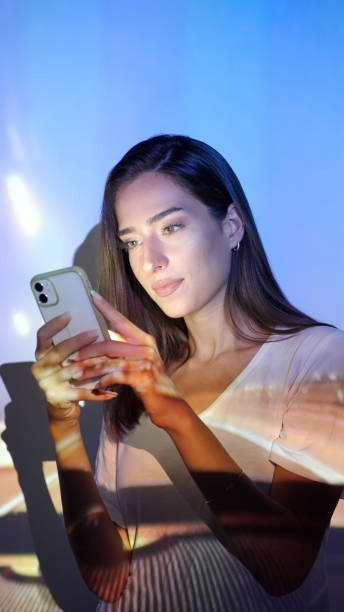 istock Image projection on a woman using a smart phone 1341661214