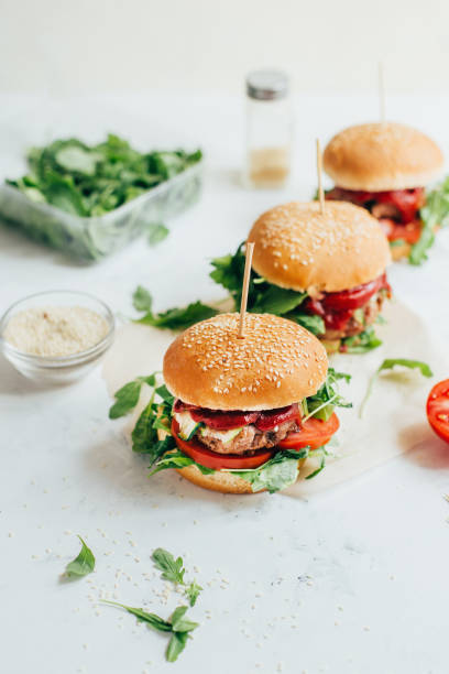 istock close-up of three burgers on a white table 1341662773