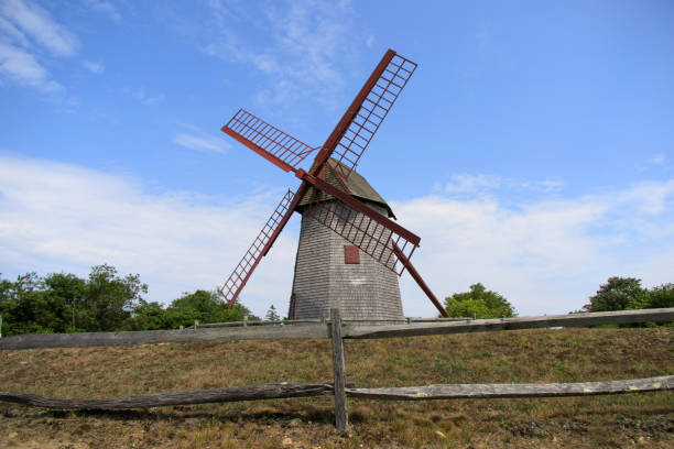 istock tall old gray windmill with spinning arms 1341663340