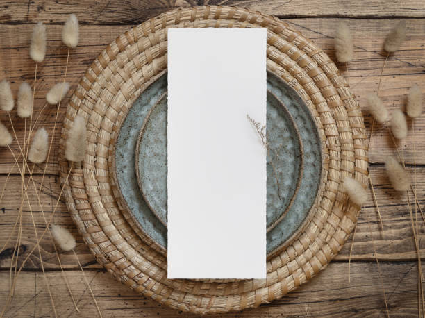 istock Blank paper card on plates with dried plants 1341664409