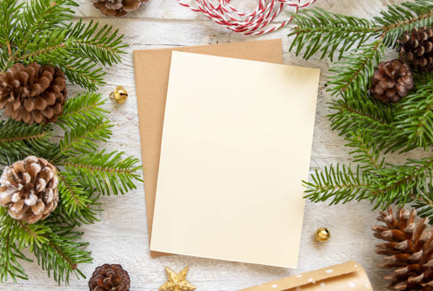 istock Christmas Composition with a blank card over wooden table flat lay. Holiday mockup 1341664429