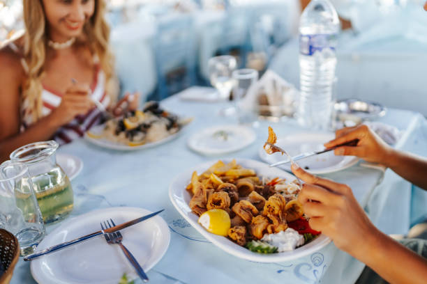 istock Female friends enjoying lunch together 1341664746