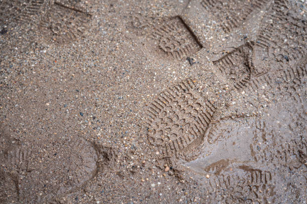 Frozen road dirt with a trace of one boot. Background texture