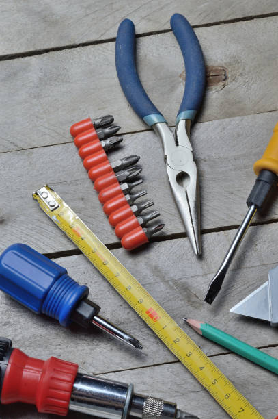 istock some home repair tools lie on a wooden background. close-up. 1341665122