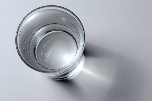 istock glass cup with drinking water on a light background. close-up. view from above 1341665539