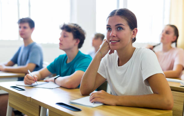 istock Pupils sitting in class and listening 1341666510