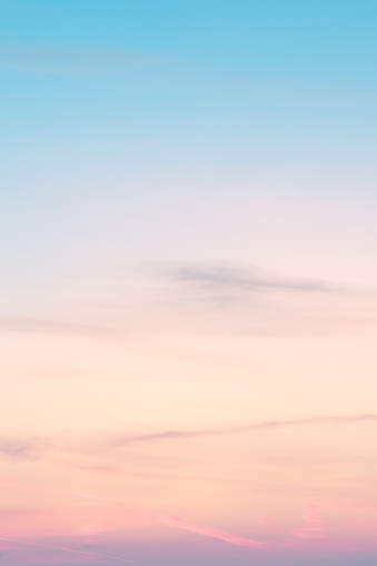 Vertical ratio size of sunset background. sky with soft and blur pastel colored clouds. gradient cloud on the beach resort. nature. sunrise.  peaceful morning. Instagram toned style