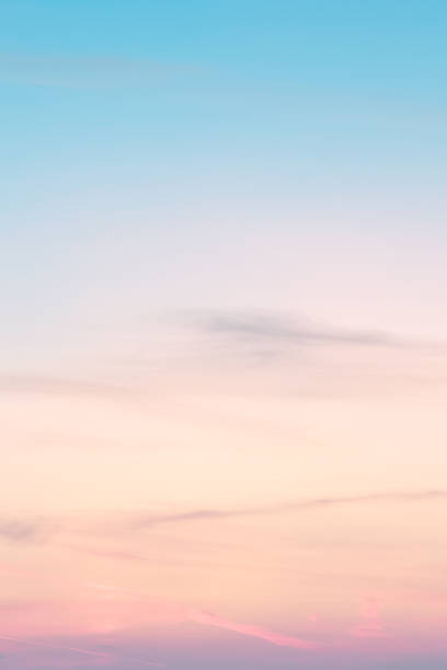 Vertical ratio size of sunset background. sky with soft and blur pastel colored clouds. gradient cloud on the beach resort. nature. sunrise.  peaceful morning. Instagram toned style stock photo