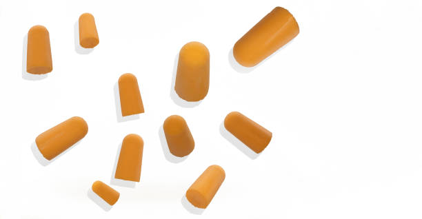 istock silicone, foam, orange plugs in various sizes floating on a white background, protection against sound and noise 1341670236