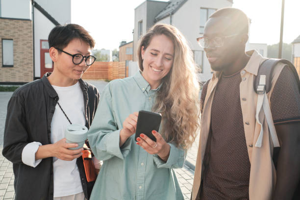 istock Friends Watching Something On Smartphone 1341672270