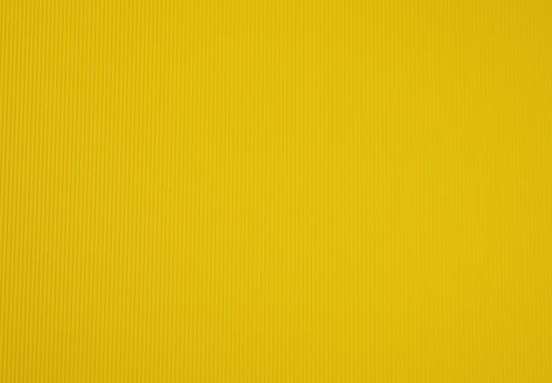 istock corrugated cardboard yellow color, abstract background for designer 1341675017