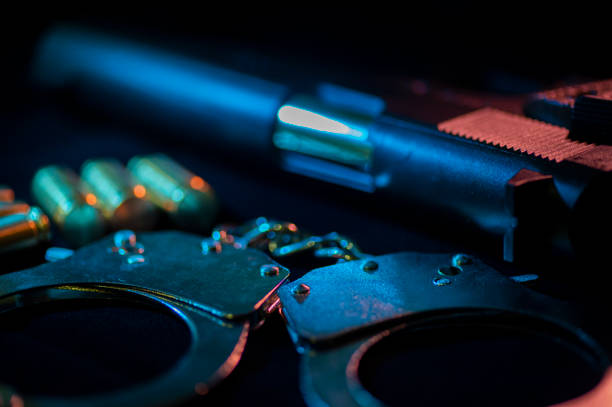 gun ,bullets and handcuffs with black background
