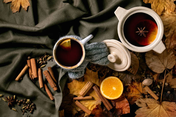 istock Hot mulled wine with spices and autumn leaves 1341679447
