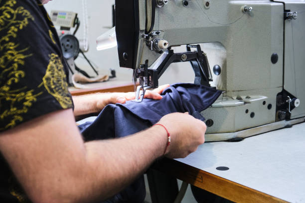 istock Cropped view of hands of a unrecognizable person using sewing machine 1341679698