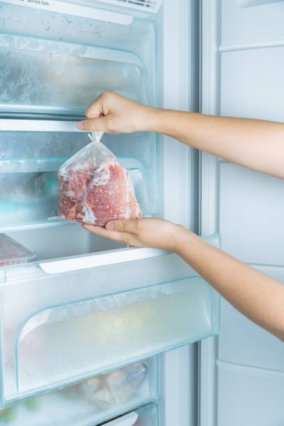 istock Taking frozen meat from the modern no-frost freezer 1341680468