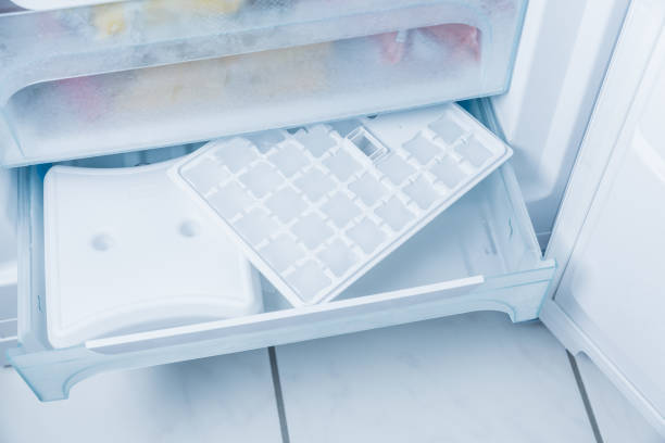 istock Ice cube maker in modern freezer with no-frost, household concept 1341680677