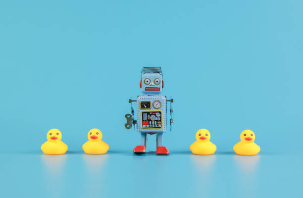istock vintage retro robot and Yellow Rubber Bath Ducks, leadership concept 1341681286