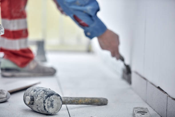 istock Ceramics tile man worker placing new tiles on the floor and wall. 1341682723