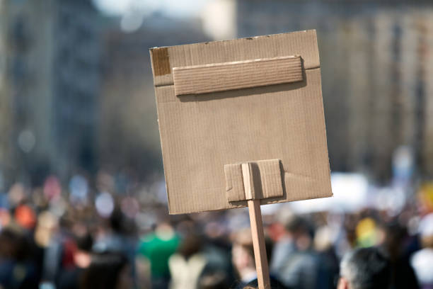 istock Protesters holding placards and signs on the streets. 1341683507